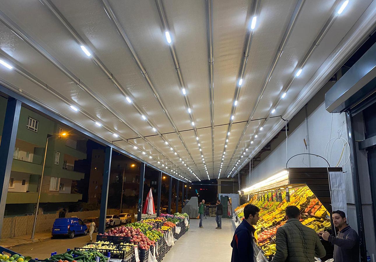 Awning pergola with LED lighting over a café terrace