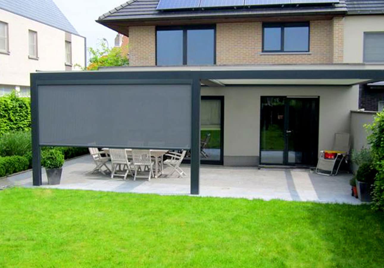 Motorised zip screen blinds closing the side of a garden pergola
