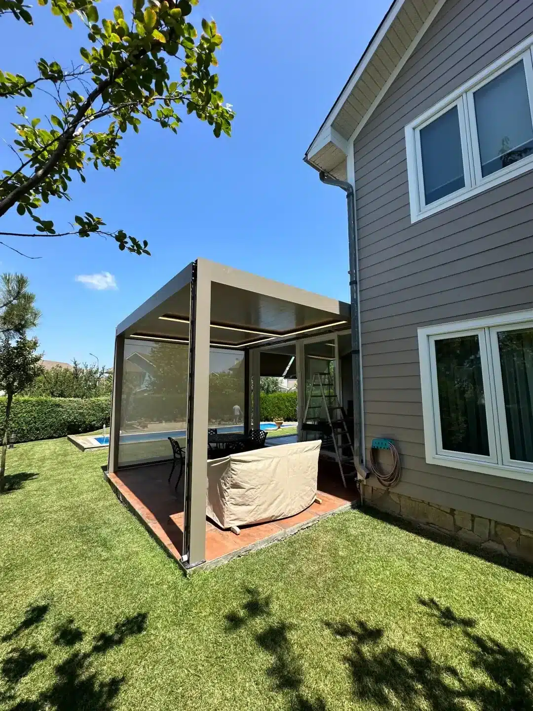 Aluminium louvred pergola in a garden