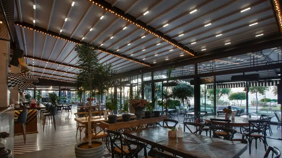 Folding awning pergola roof over a café