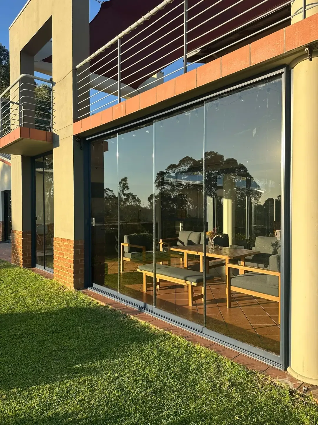 Frameless glass room lit in the evening