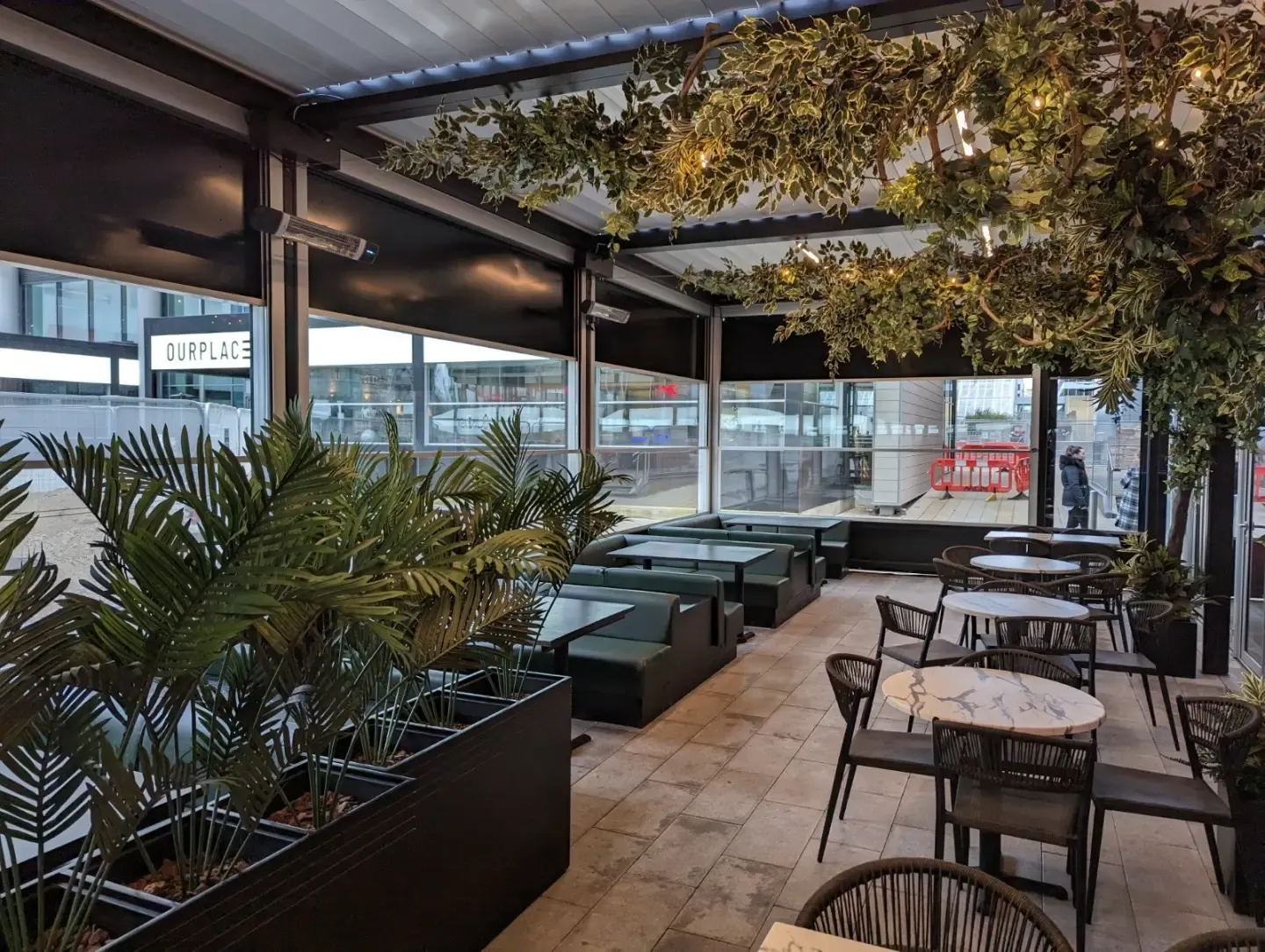 Café terrace enclosed with guillotine glass