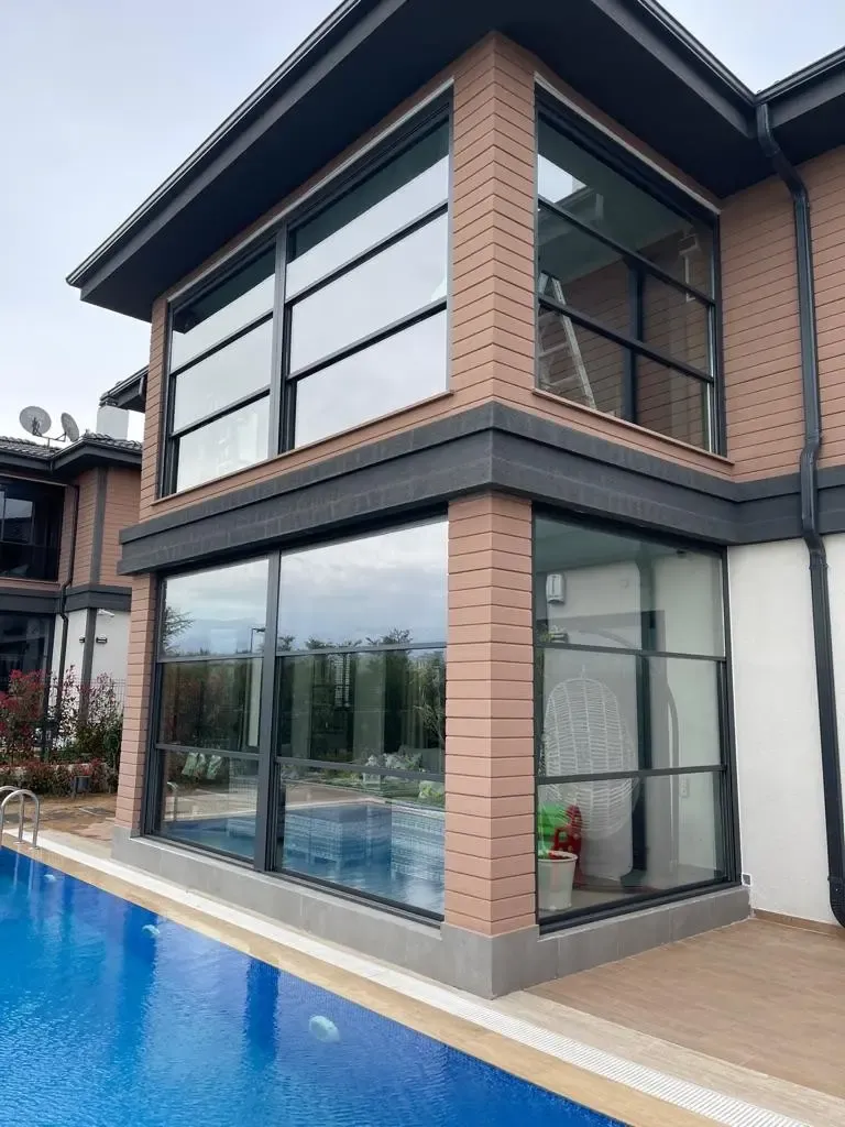 Poolside villa corner glazed with guillotine glass