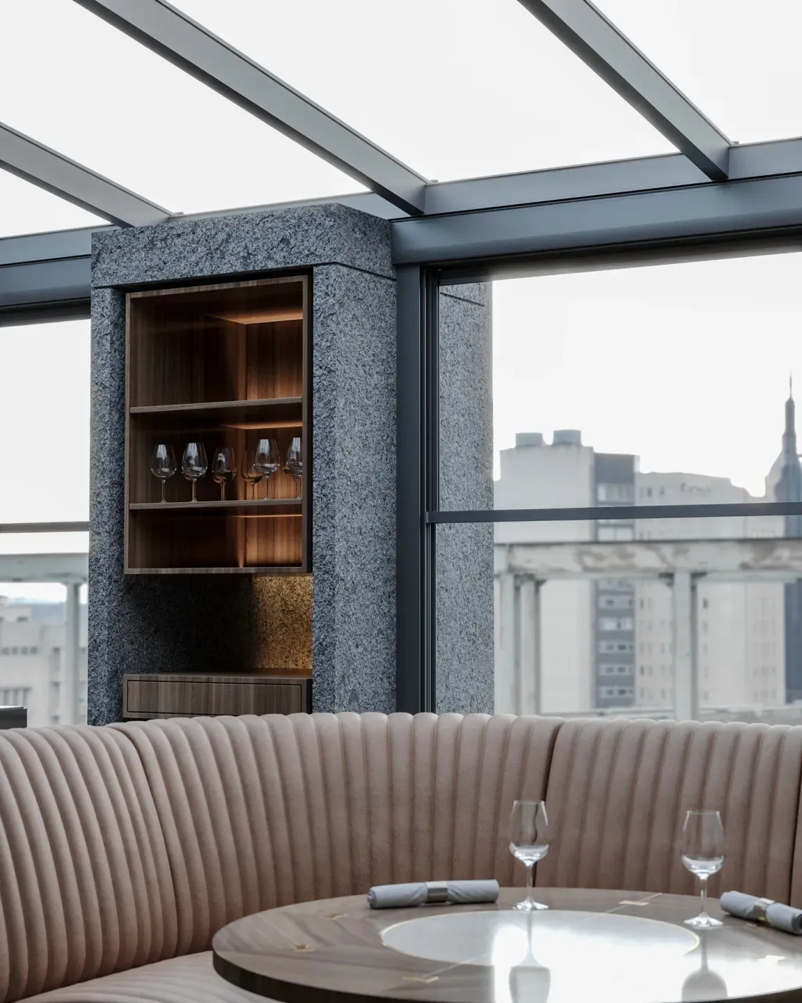 Booth seating beside a guillotine glass wall