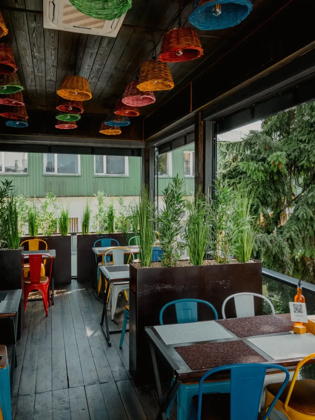 Terrace with pendant lighting behind guillotine glass