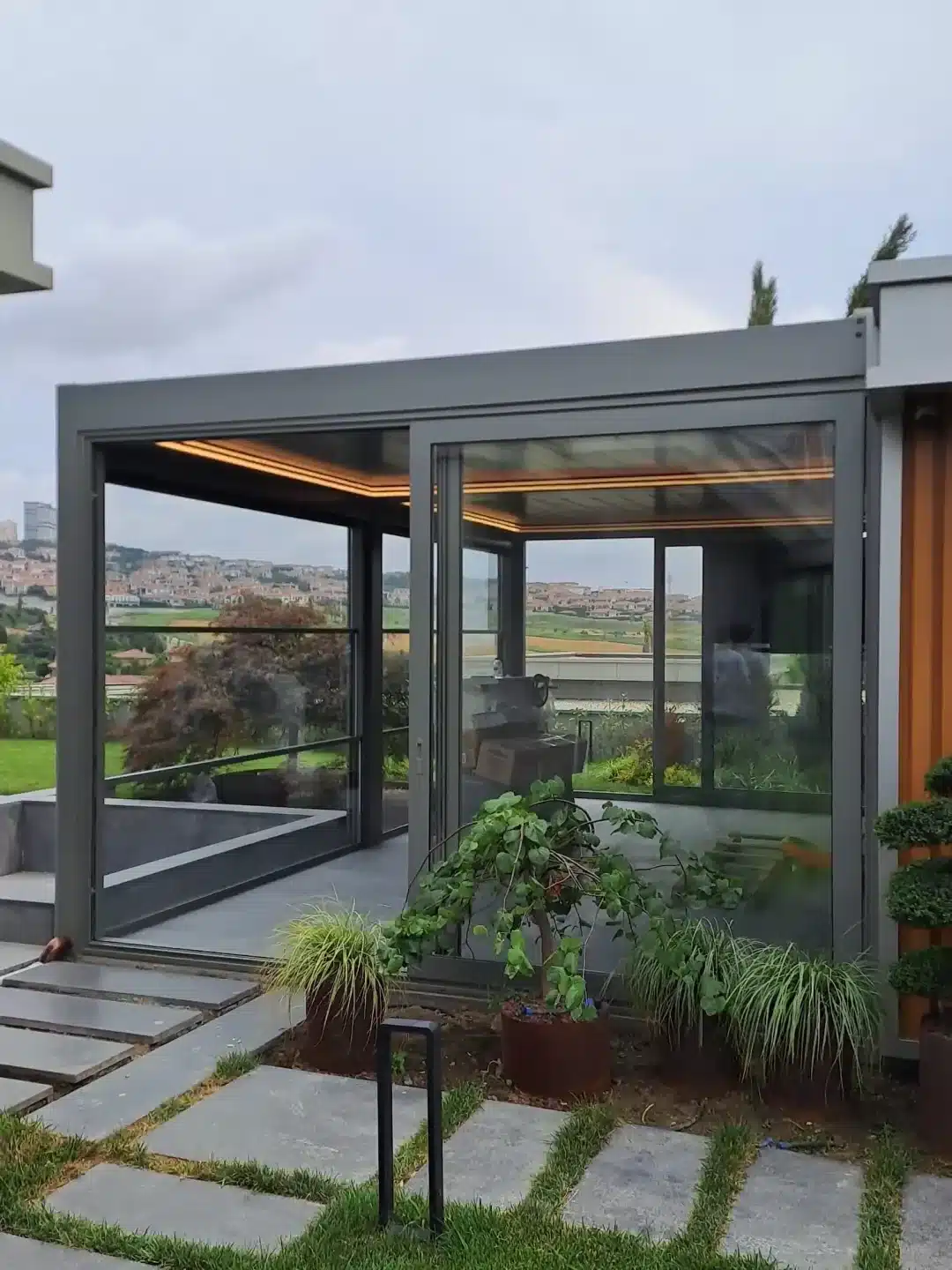 Louvred pergola enclosed with glass