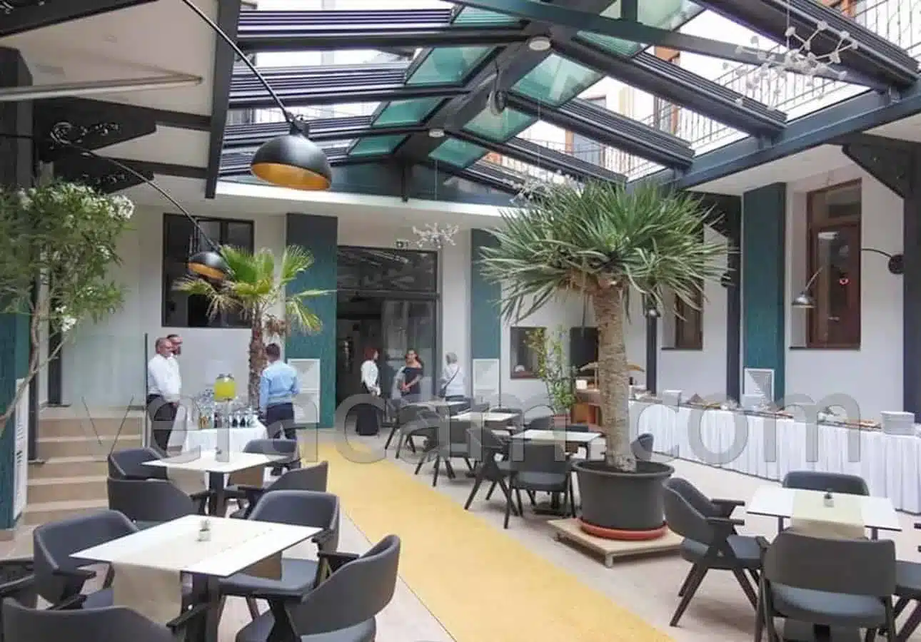 Restaurant courtyard covered by a retractable glass roof