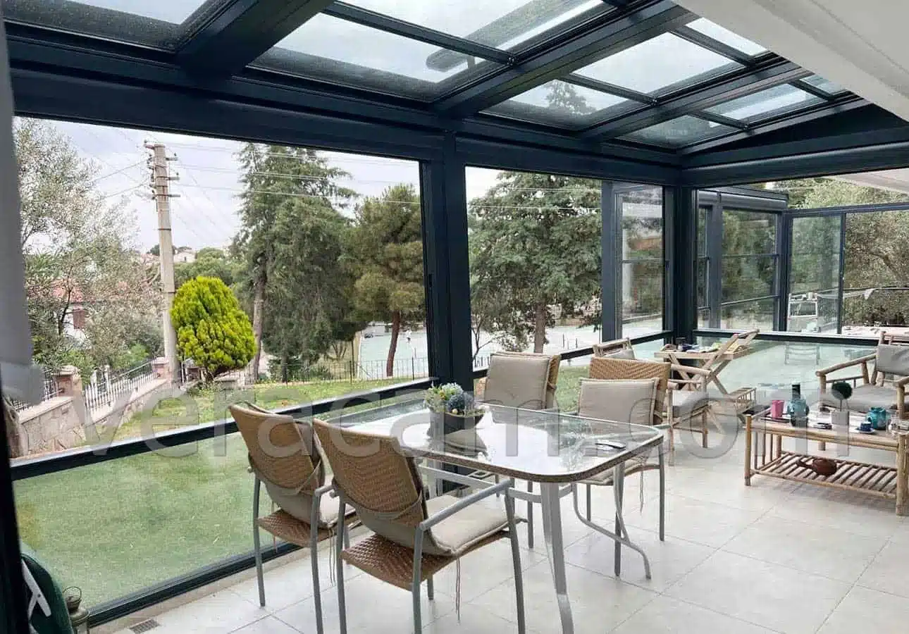 Terrace dining area under a motorised retractable glass roof